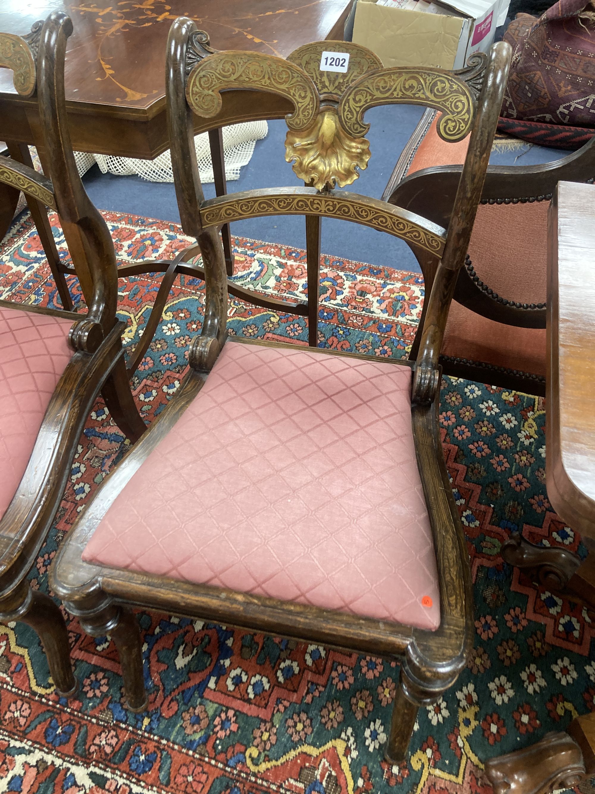 A pair of Regency beech simulated rosewood brass inlaid dining chairs, with pink upholstered seats